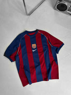 Vintage 2000-2001 Barcelona home jersey showcasing iconic blue and red Blaugrana stripes in a classic football design.