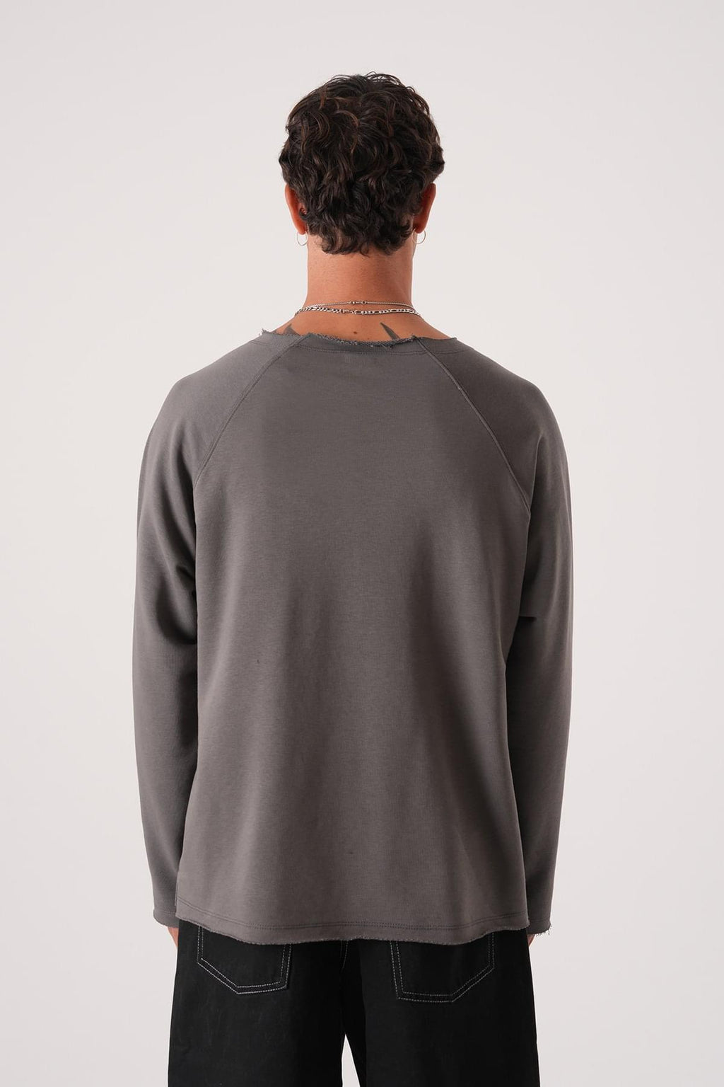 Unisex Oversized Raglan Sweatshirt - Raw Hem Detail.