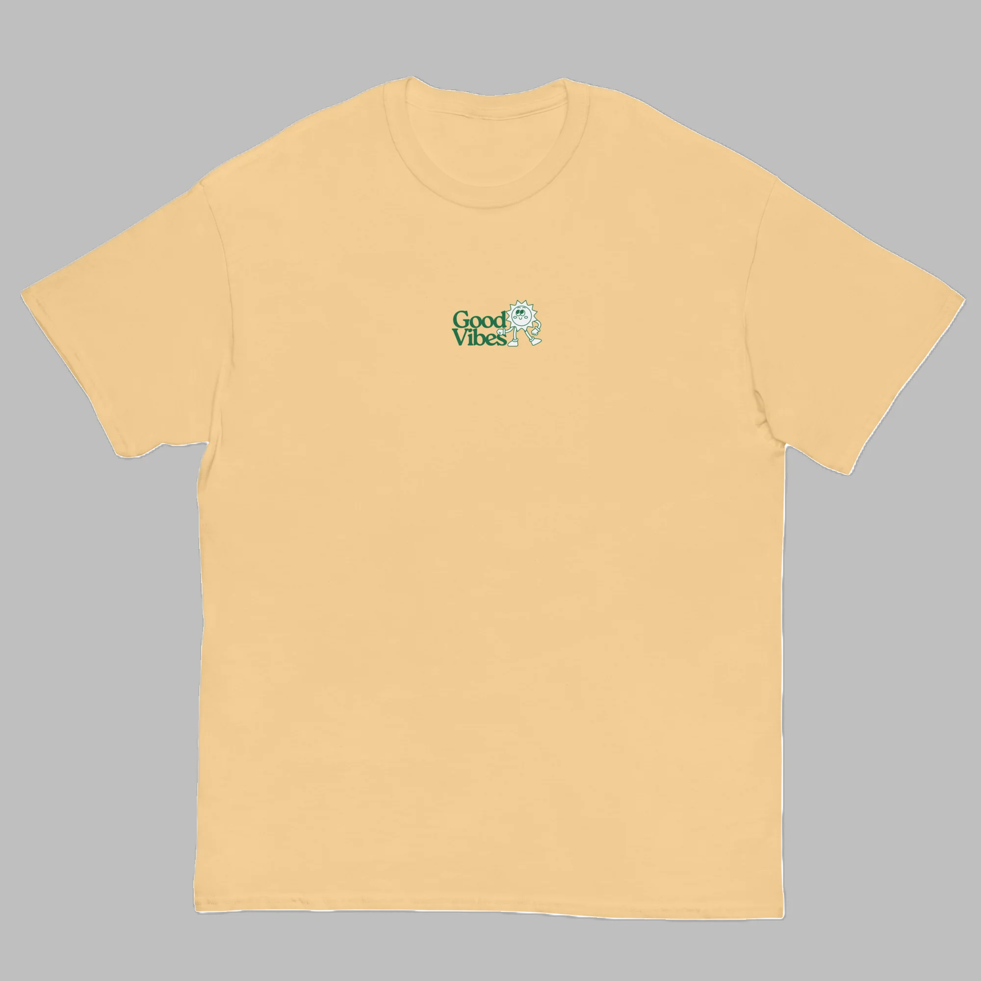 Pastel yellow crewneck t-shirt with small green Good Vibes chest logo graphic print front view