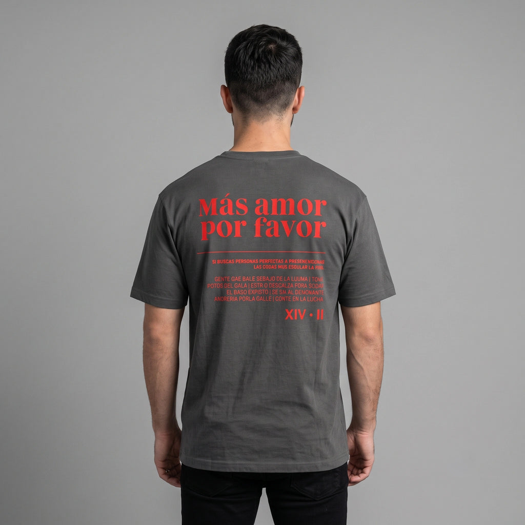 Back view of male model wearing faded black heavyweight garment-dyed t-shirt with red Mas Amor Por Favor text print