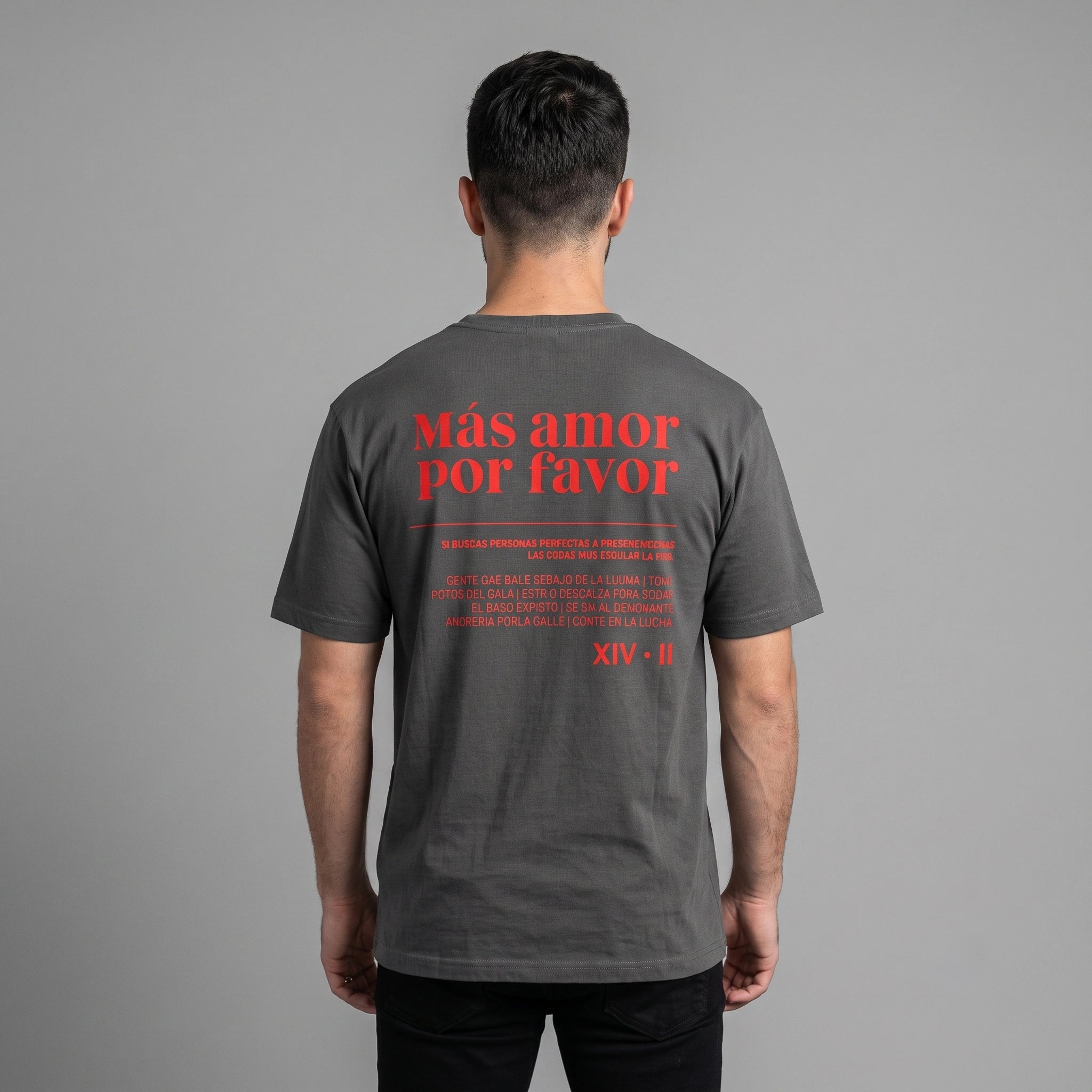 Back view of male model wearing faded black heavyweight garment-dyed t-shirt with red Mas Amor Por Favor text print