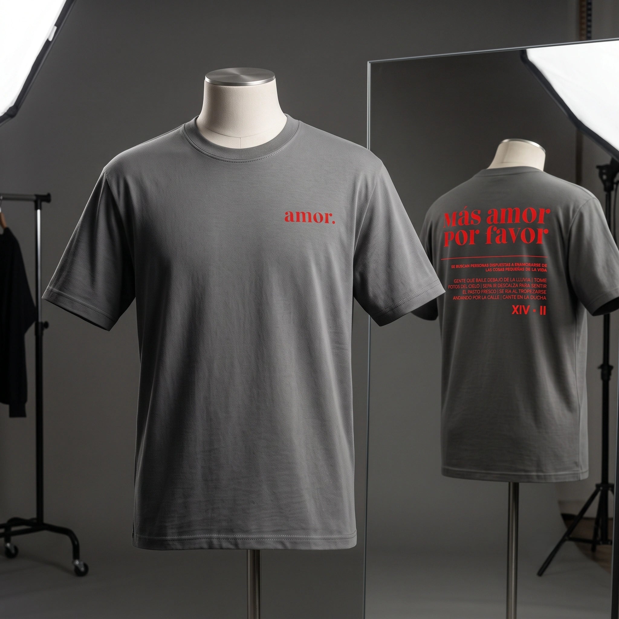 Studio mannequin display showing front and back views of men's faded black heavyweight garment-dyed t-shirt with red amor and Mas Amor Por Favor print