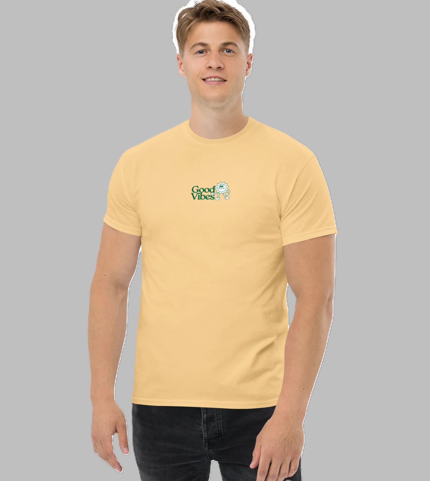 Front view of male model standing wearing light yellow crewneck graphic t-shirt with small green Good Vibes chest design