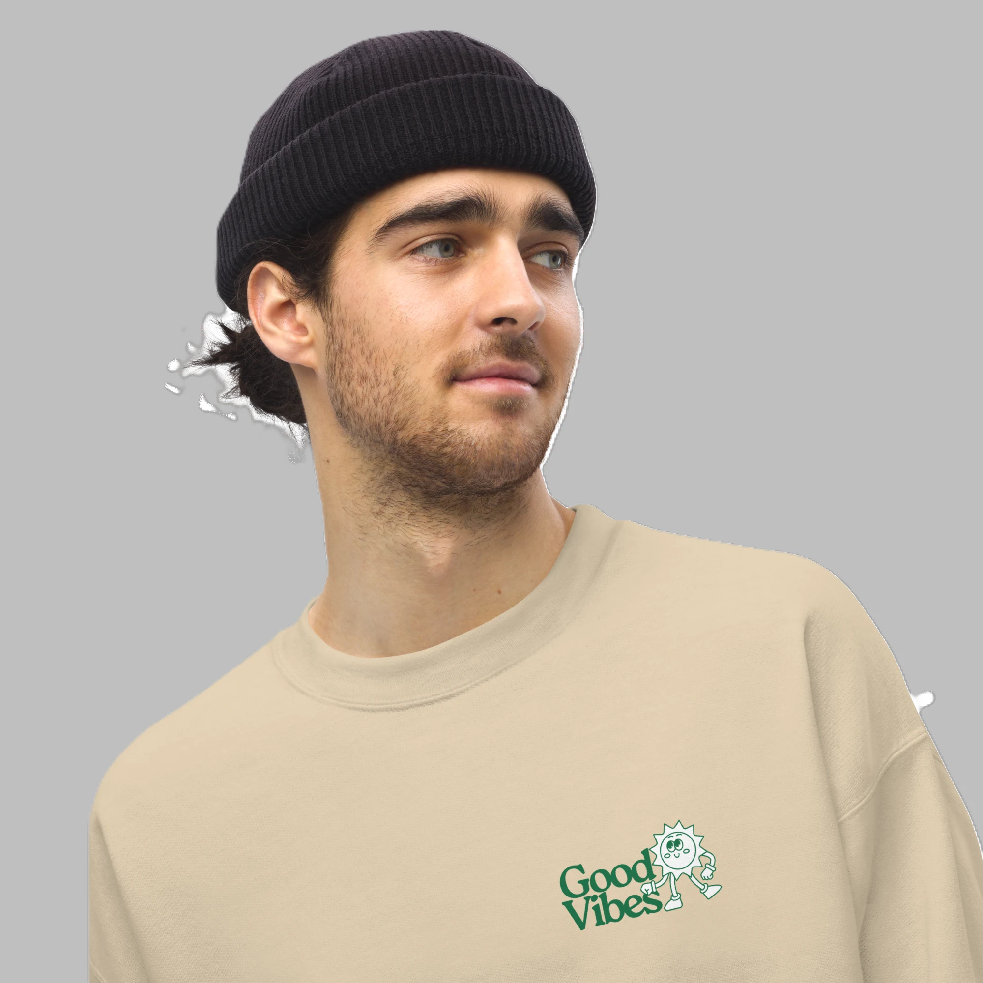 Close-up shot of male model wearing sand beige crewneck sweatshirt with green Good Vibes chest print