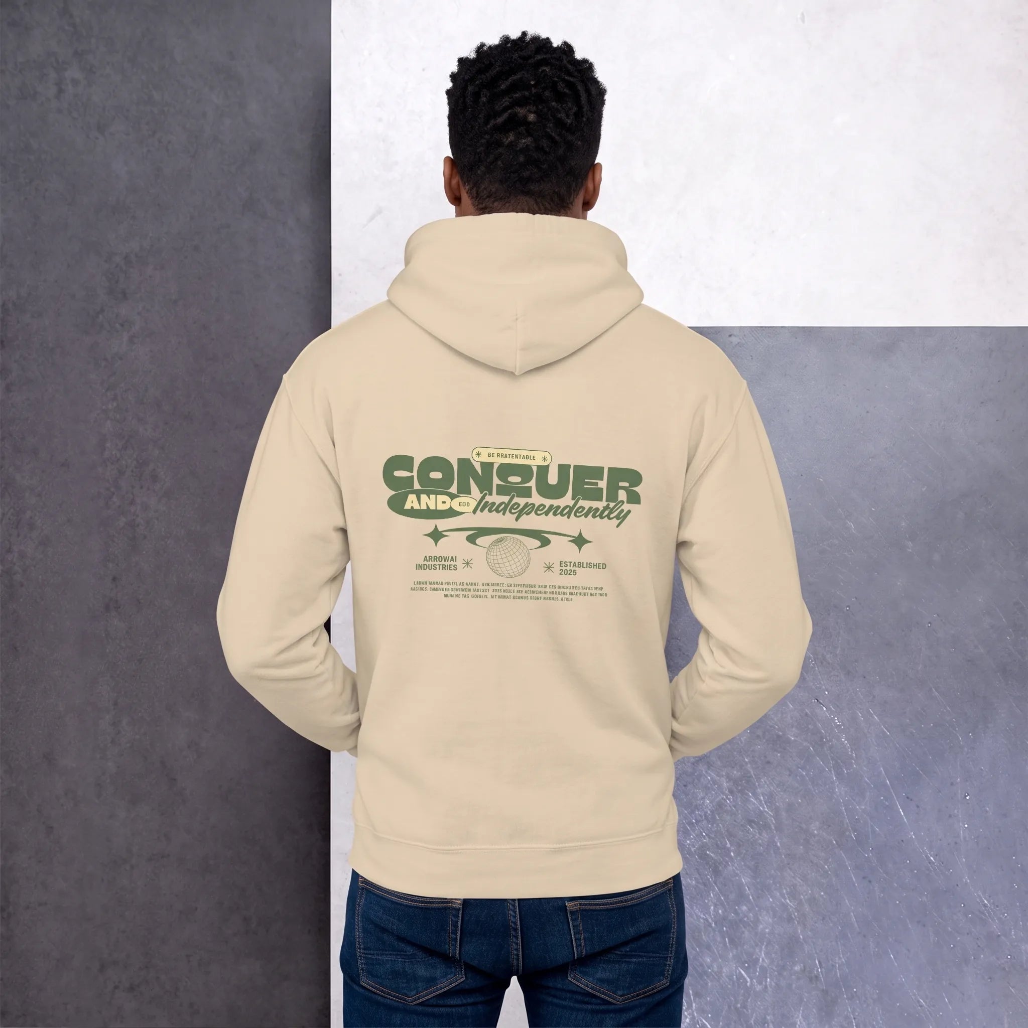 Back view of a men's sand beige vintage-style hoodie with a green graphic print featuring the words 'CONQUER AND INDEPENDENTLY'