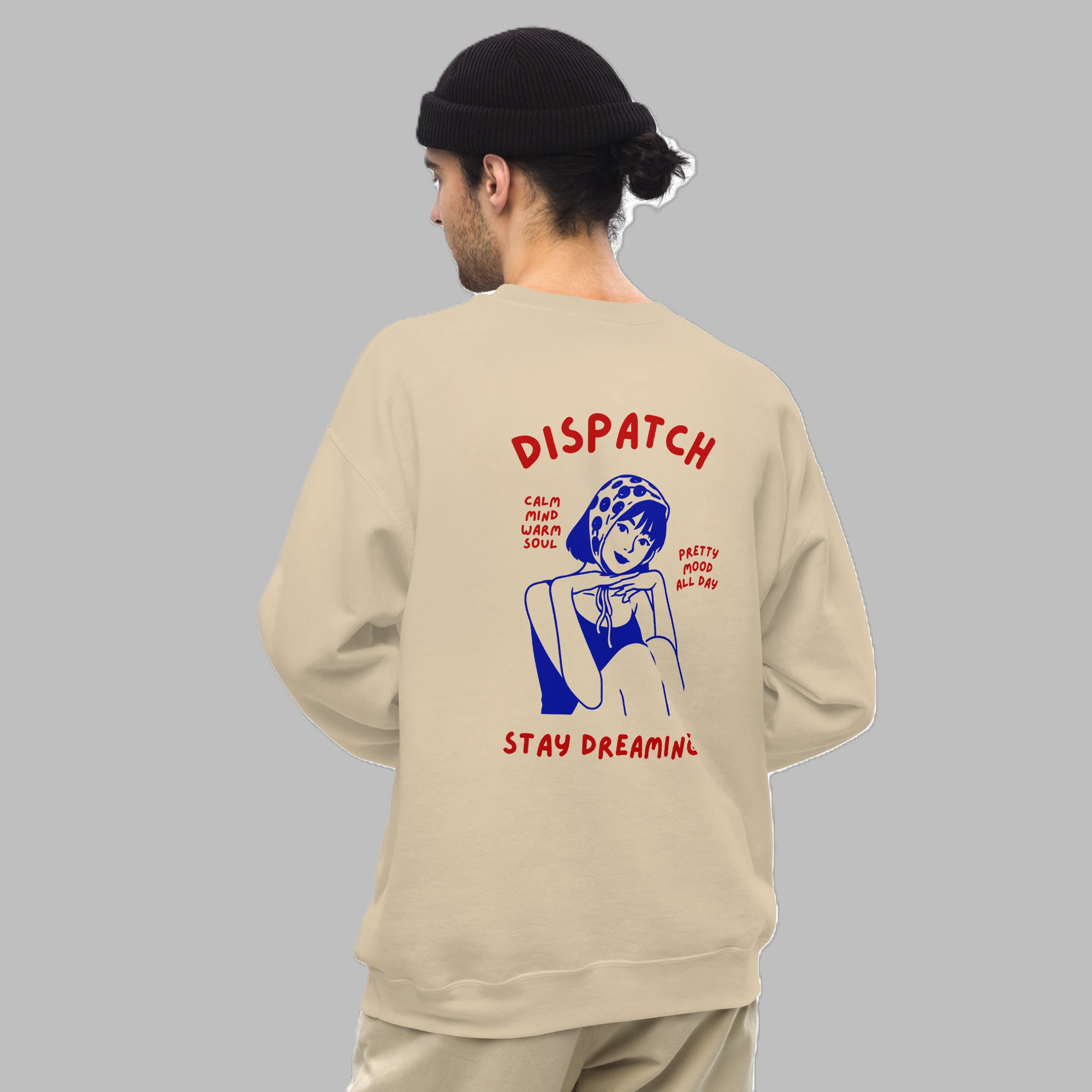 Male model wearing sand beige crewneck sweatshirt with retro Dispatch Stay Dreaming back print design