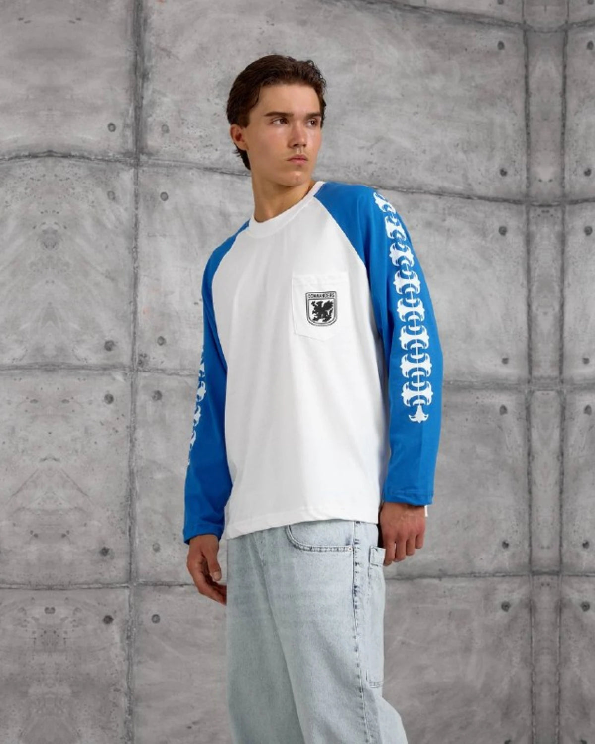 Gothic Sleeve Crest Pocket Raglan Sweatshirt in Royal Blue by Withinblack