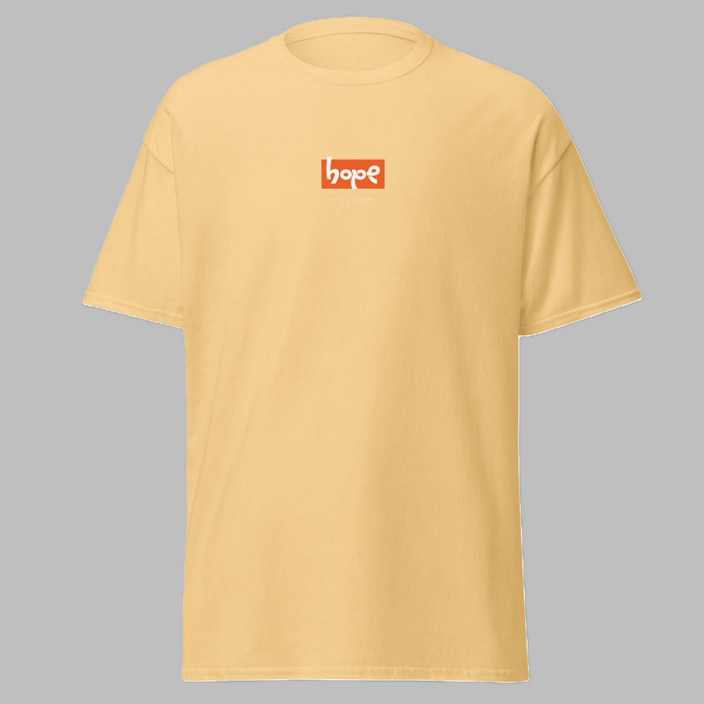 Front angled view of a pastel yellow crewneck t-shirt featuring an orange 'hope' box logo on the chest.