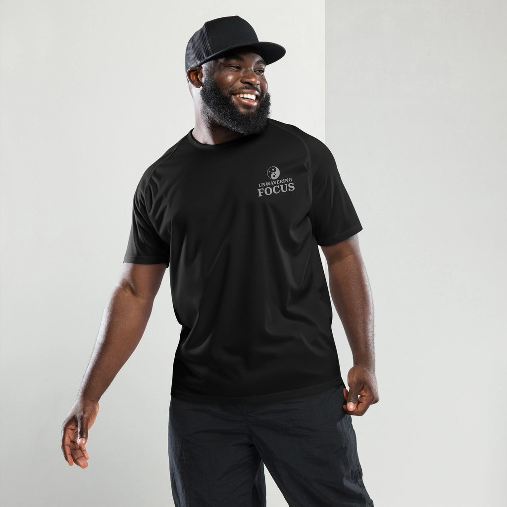Front view of a man wearing a black sports shirt with a minimalist unwavering focus yin yang logo on the chest.
