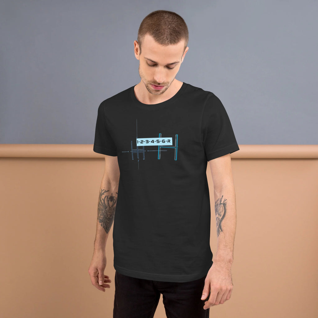 Tattooed male model wearing a dark grey 6-speed manual transmission blueprint stick shift car enthusiast graphic t-shirt