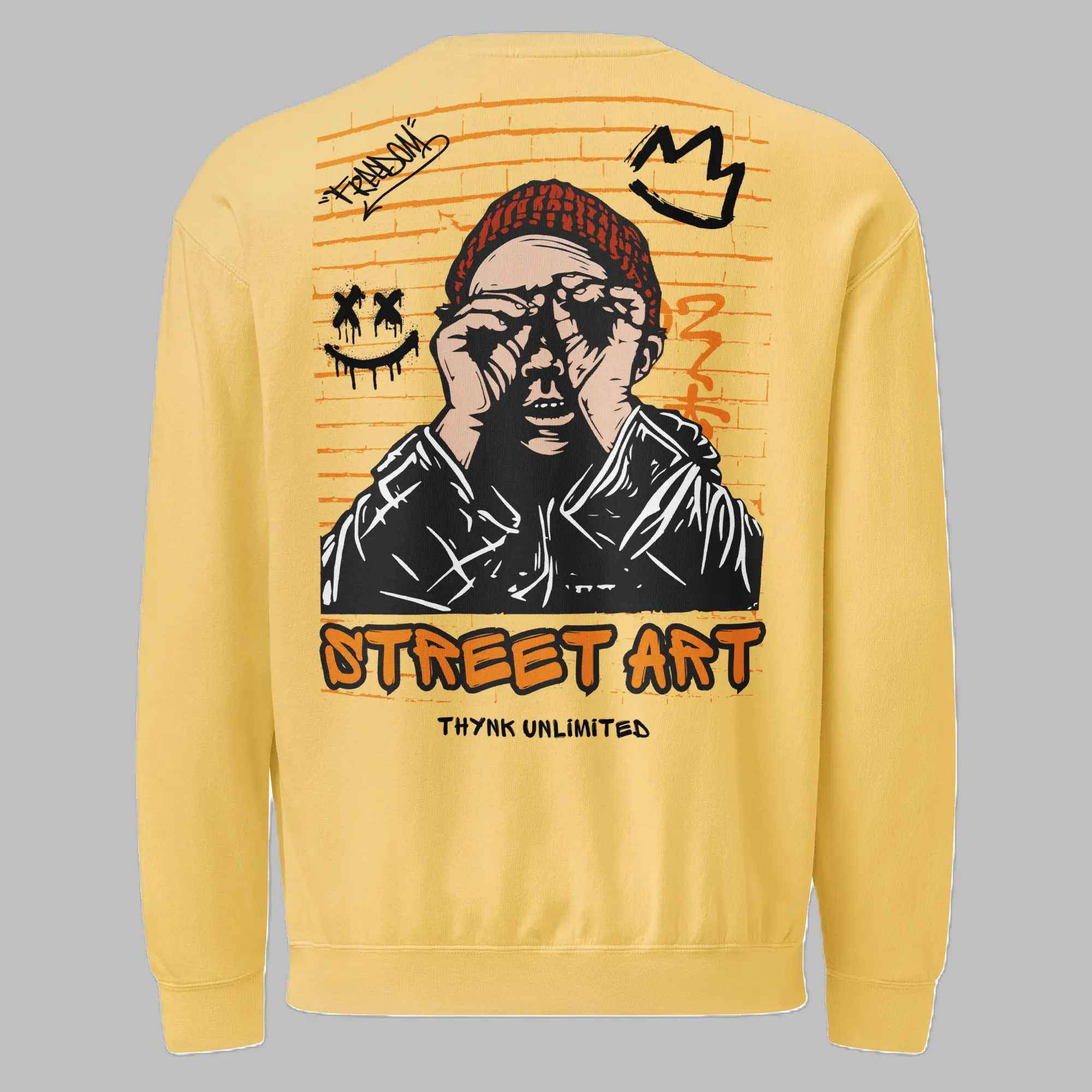 Back view of a yellow crewneck sweatshirt featuring a large brick-pattern street art graphic of a person wearing a red beanie, binoculars gesture, graffiti crown, and smiley face, with 'STREET ART' and 'THYNK UNLIMITED' printed below.