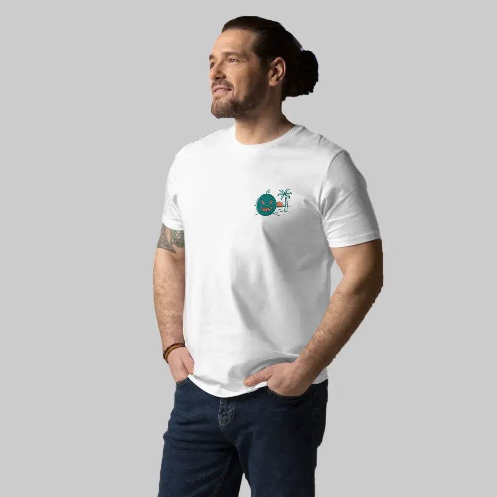 Close-up of the left-chest graphic on a male model in a white organic cotton t-shirt, featuring a green carved 'Summerween' jack-o-lantern and a palm tree, against a light grey background.