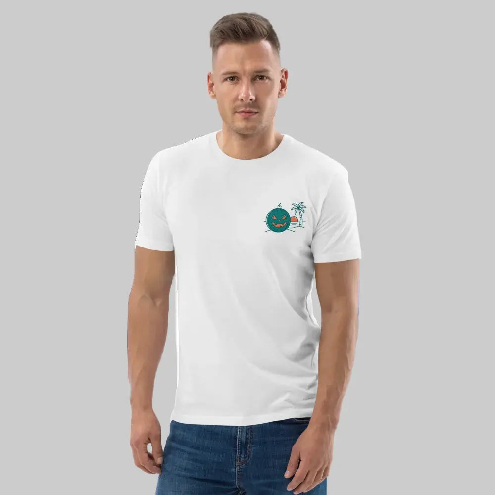 Front-facing half-body portrait of a male model wearing a white organic cotton unisex t-shirt, featuring a left-chest graphic of a Summerween green tropical jack-o-lantern and palm tree, against a light grey background.