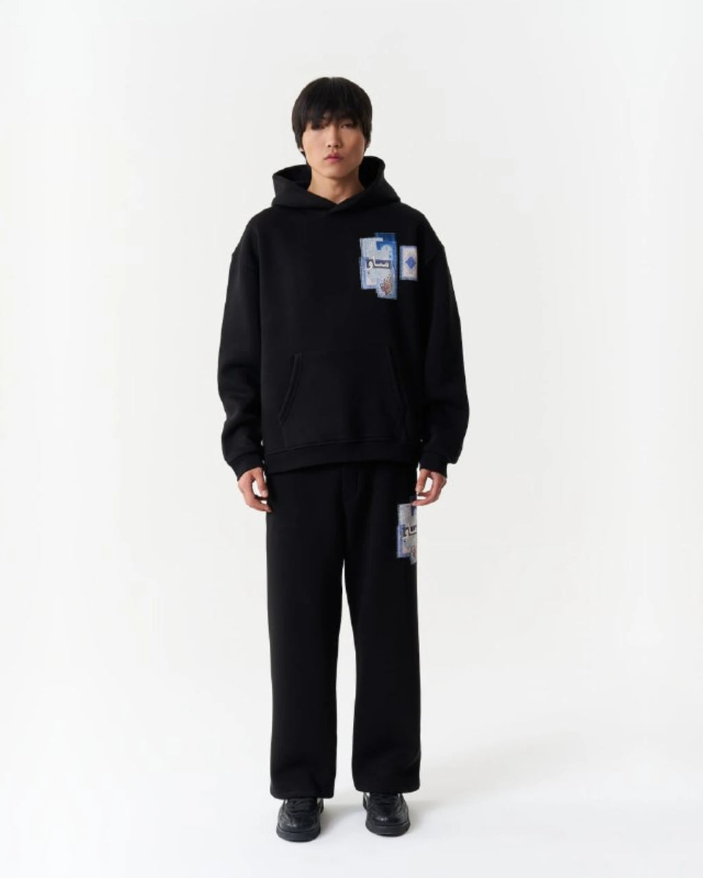 Blue Rug Patchwork Arabic Script Oversized Hoodie in Black - front view