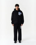 Blue Rug Patchwork Arabic Script Oversized Hoodie in Black - front view