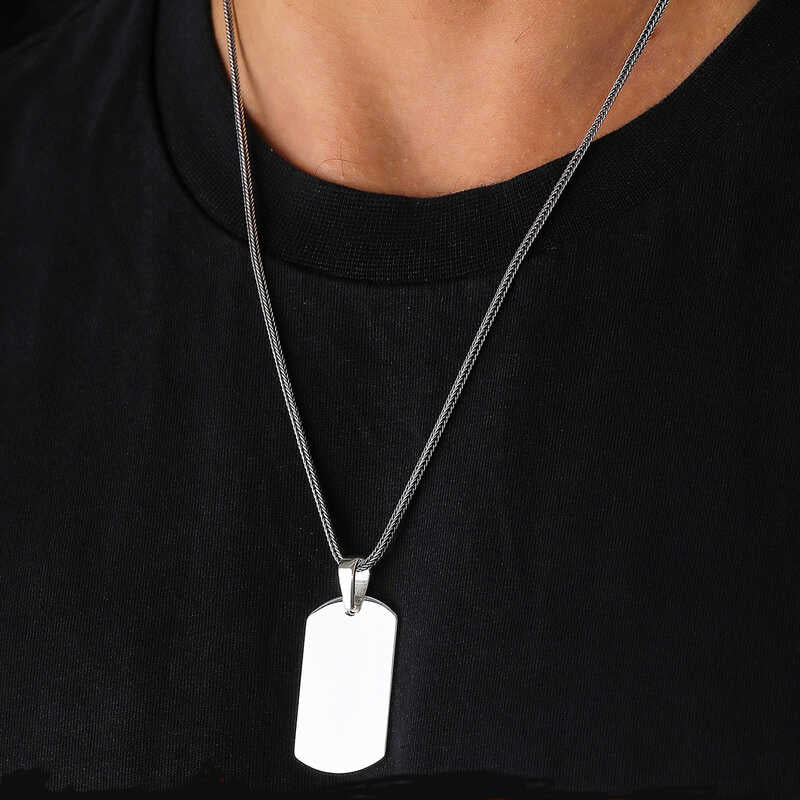 Man wearing sterling silver dog tag necklace over black t-shirt