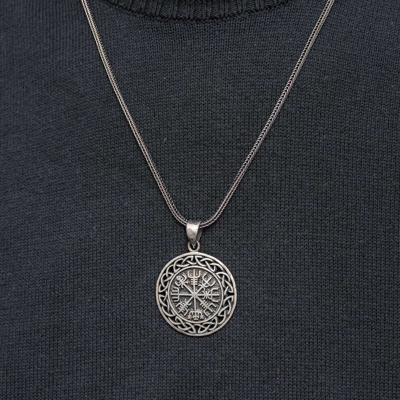 Close-up of men's Viking compass pendant necklace on chest