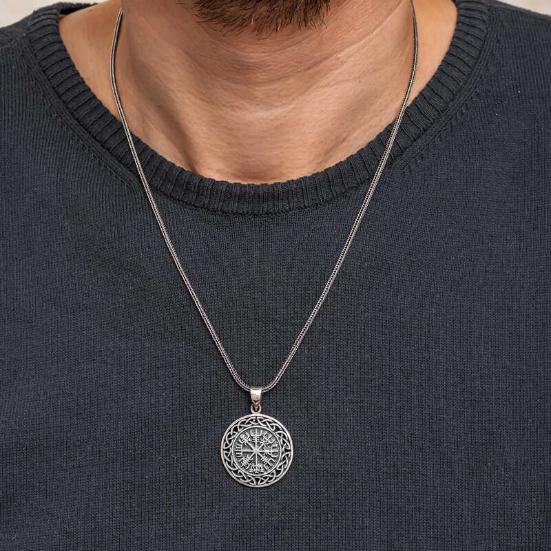 Viking compass silver necklace worn by man over black t-shirt