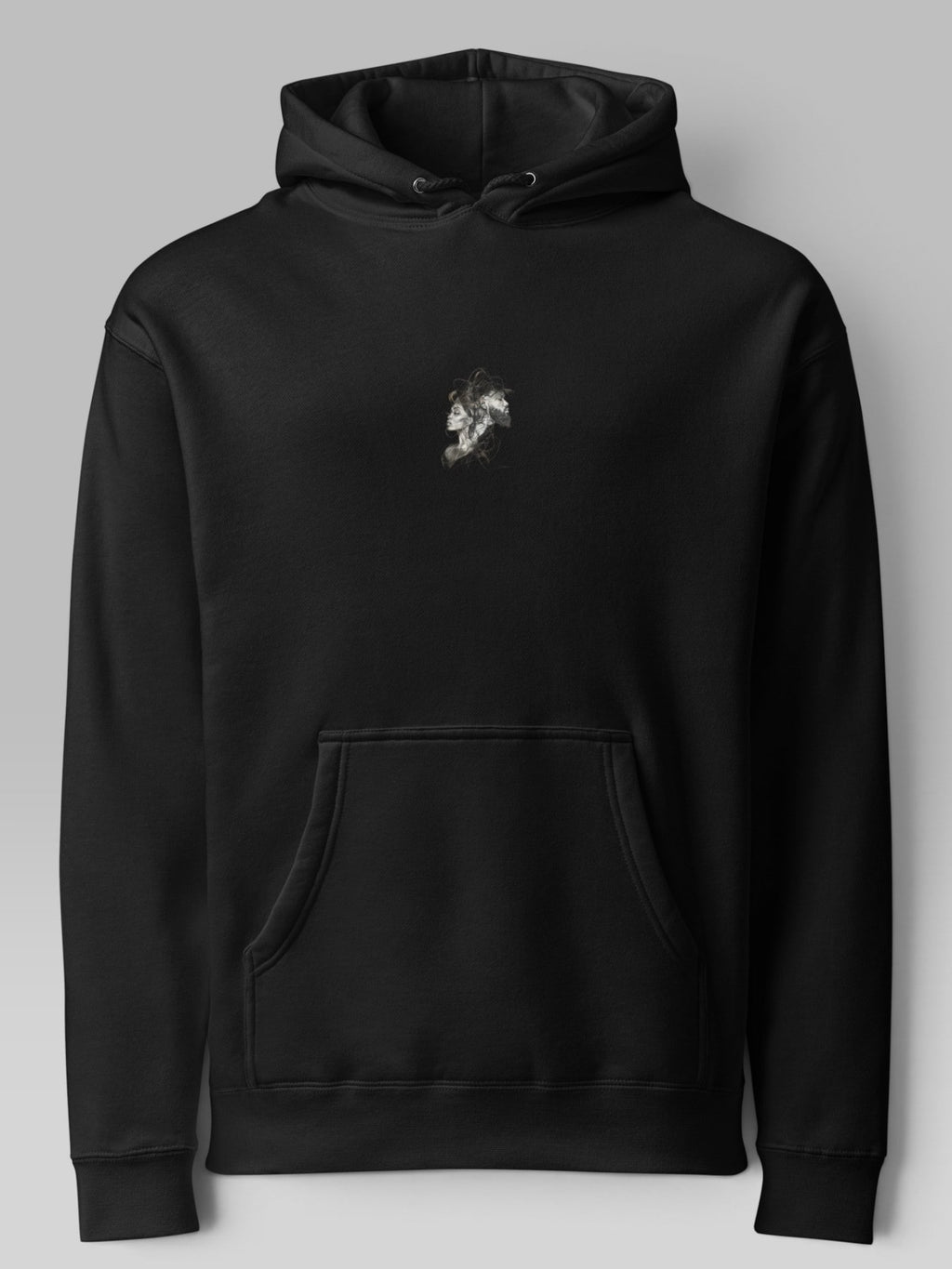 Front view of a black oversized hoodie with a small chest graphic and kangaroo pocket