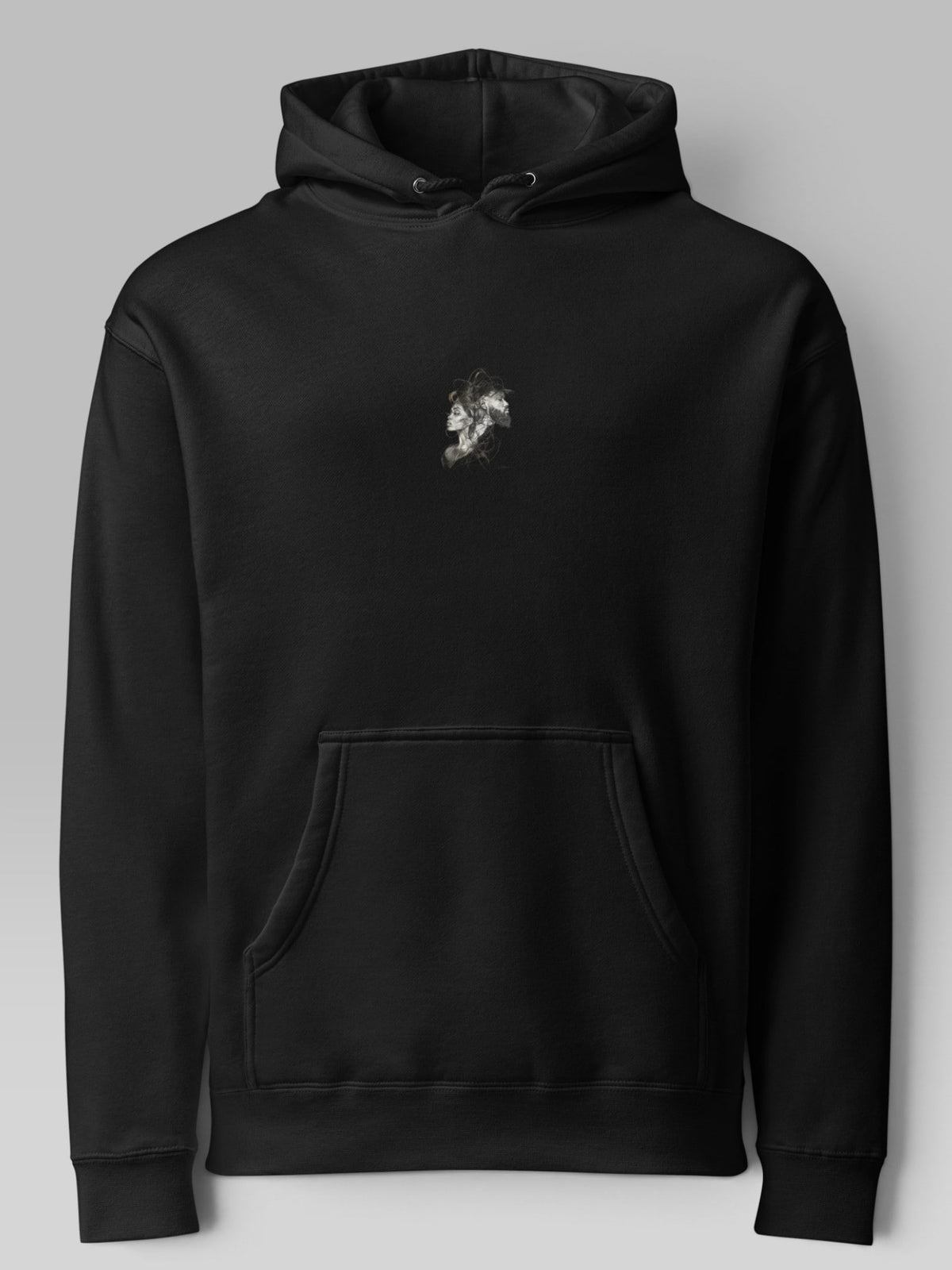 Front view of a black oversized hoodie with a small chest graphic and kangaroo pocket
