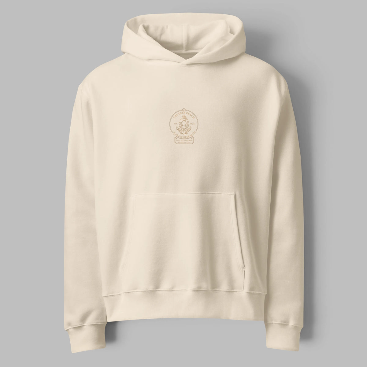 Flat lay front view of an oversized cream hoodie featuring minimal center graphic print and pouch pocket