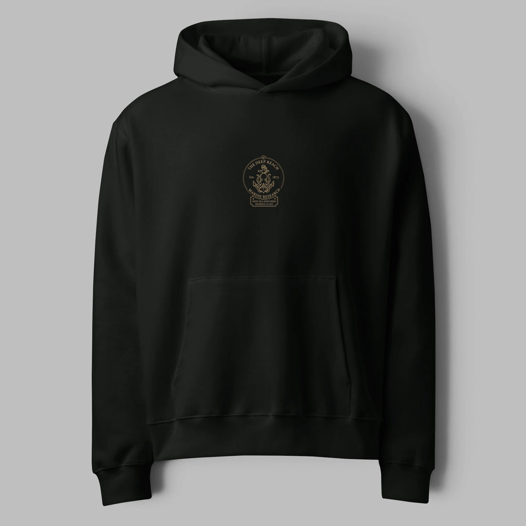 Flat lay front view of a washed vintage black oversized hoodie featuring a minimal center graphic print and pouch pocket