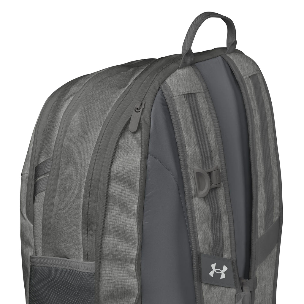 Close-up view of Under Armour UA Storm Commuter Backpack in Castlerock grey, highlighting the adjustable LEVELED strap system for even weight distribution.