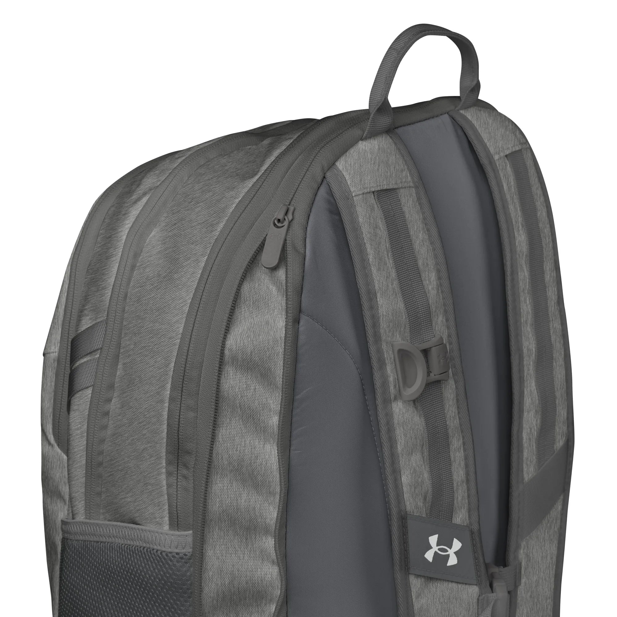 Close-up view of Under Armour UA Storm Commuter Backpack in Castlerock grey, highlighting the adjustable LEVELED strap system for even weight distribution.