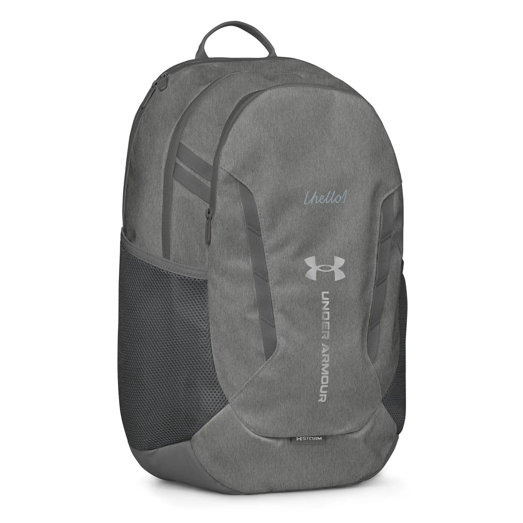 Under Armour UA Storm Commuter Backpack in Castlerock grey, right side view showing the mesh water bottle pocket and exterior design.