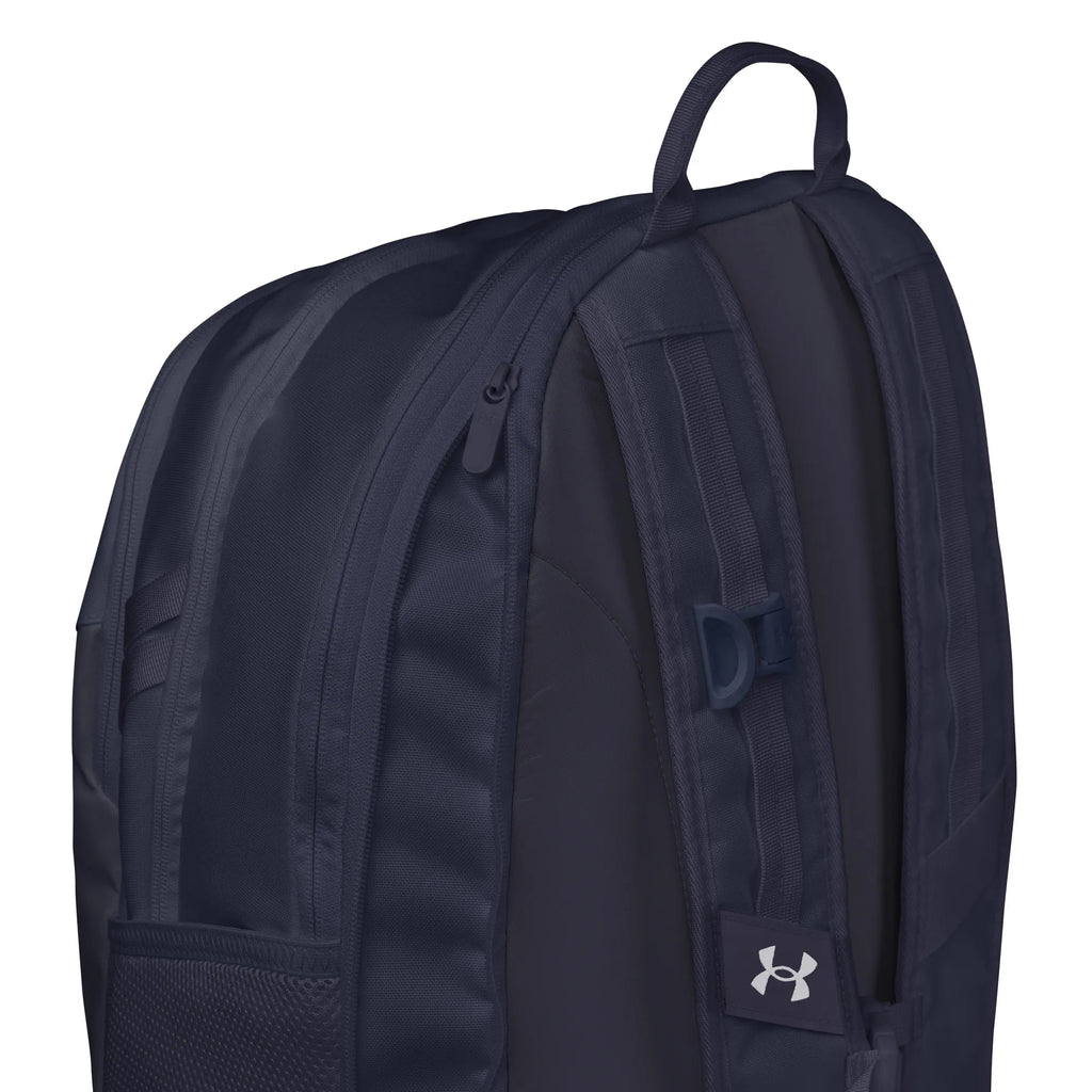 Close-up view of Under Armour UA Storm Commuter Backpack in Midnight Navy, highlighting the adjustable LEVELED strap system for even weight distribution.