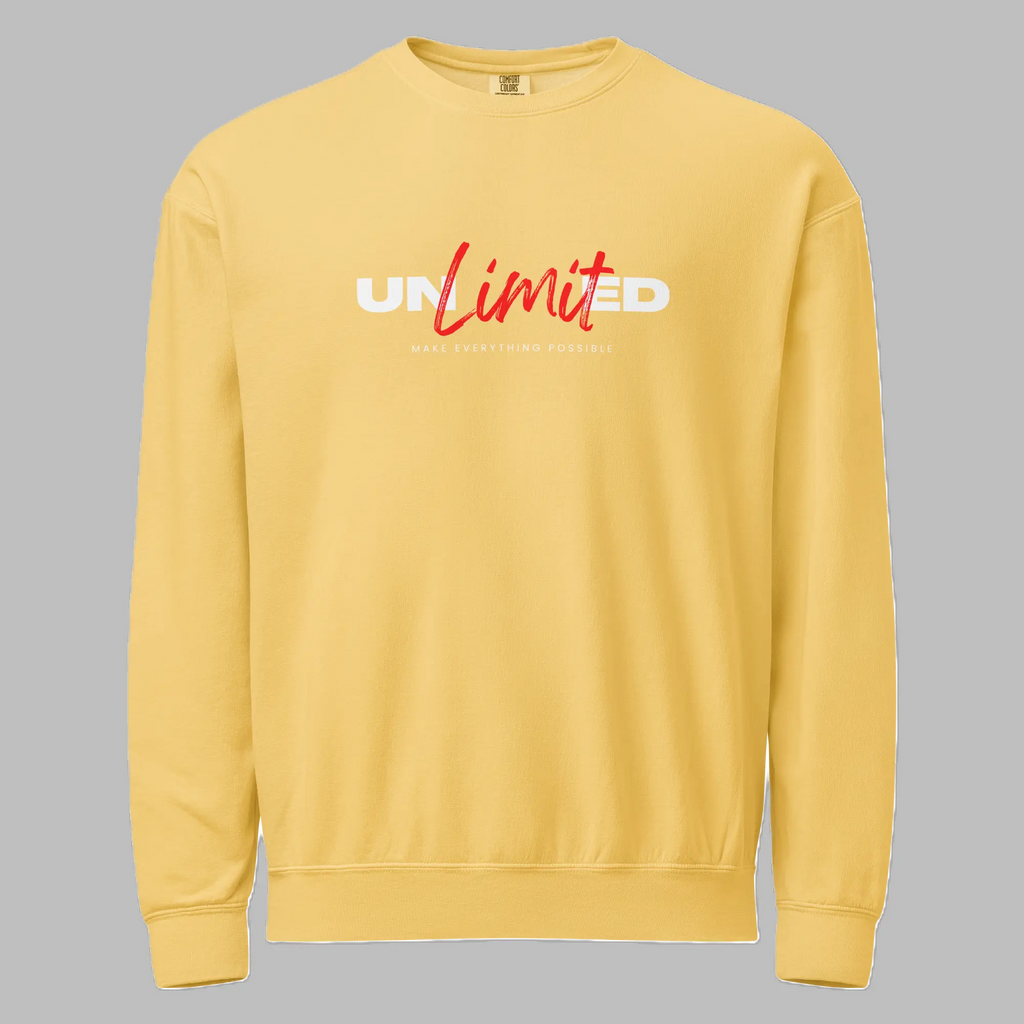 Front view of a pastel yellow crewneck sweatshirt featuring 'UNLIMITED' printed across the chest in white bold letters with 'Limit' overlaid in red script, above the small text 'MAKE EVERYTHING POSSIBLE'.