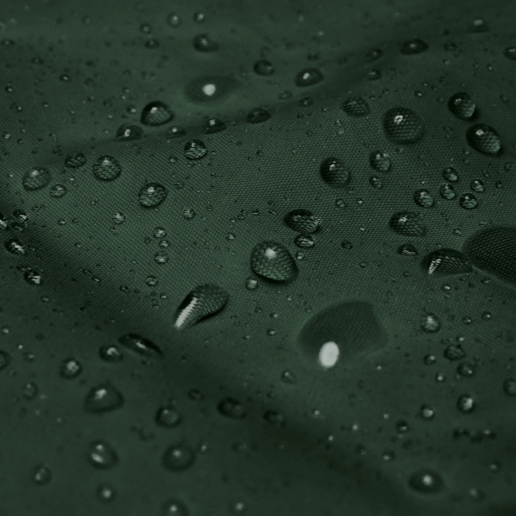 Macro close-up shot of water drops on waterproof forest green windbreaker fabric texture showcasing water-resistant feature