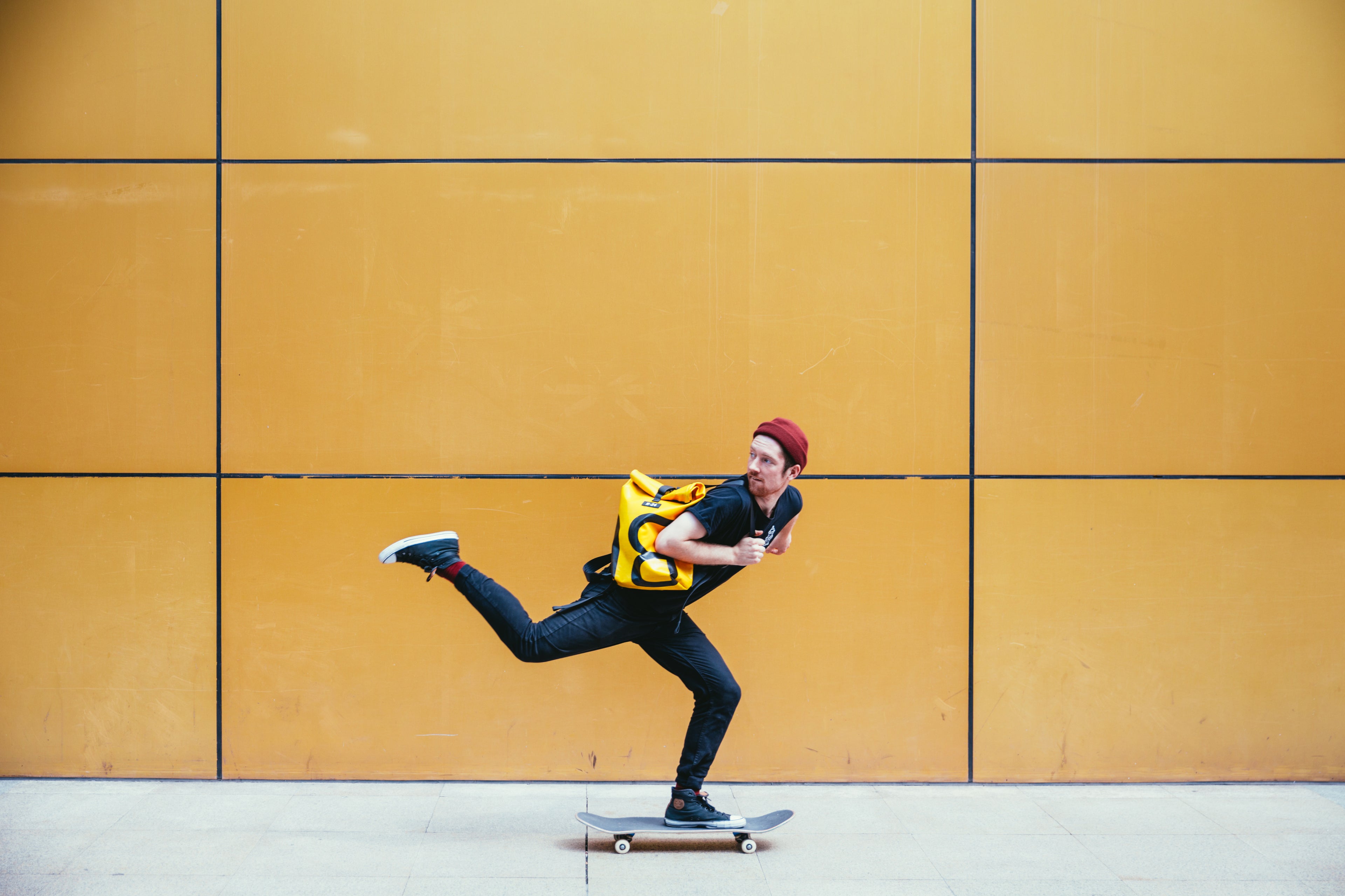 a man skateboarding with a backpack on his back